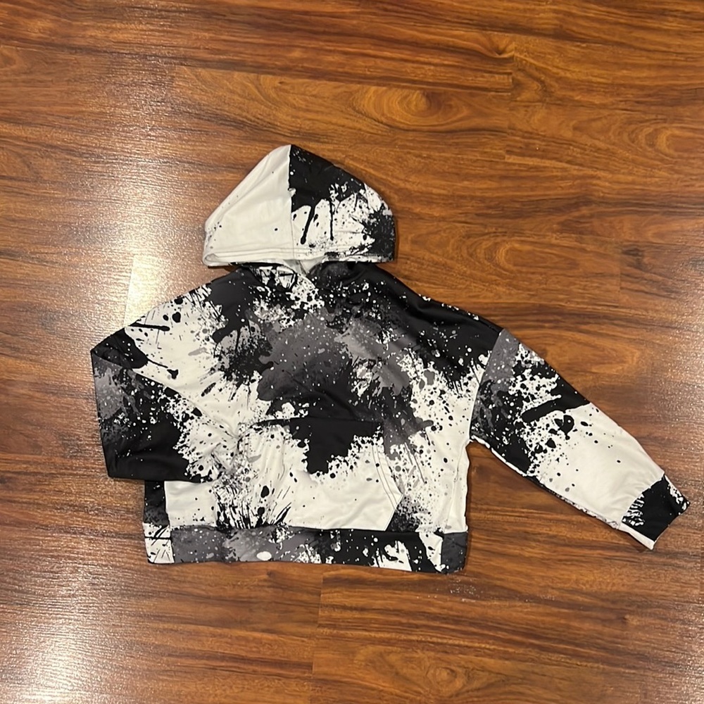 SHEIN Girls Splattered Paint Wrap Back Kangaroo Pocket Drop Shoulder Hoodie.